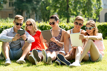 Image showing smiling friends with tablet pc computers in park