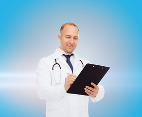 Image showing smiling male doctor with clipboard and stethoscope