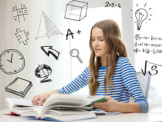 Image showing smiling student girl reading books at home