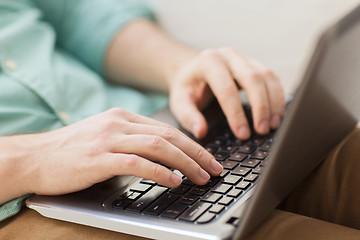 Image showing close up of man working with laptop at home