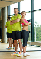 Image showing smiling man and woman in gym