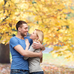 Image showing smiling couple hugging and looking at each other