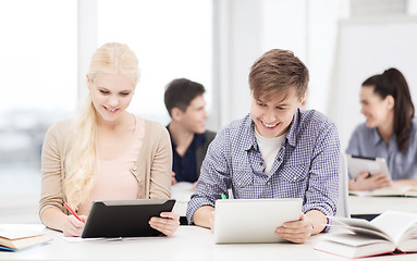 Image showing two smiling students with tablet pc at school
