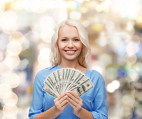 Image showing smiling young woman with us dollar money