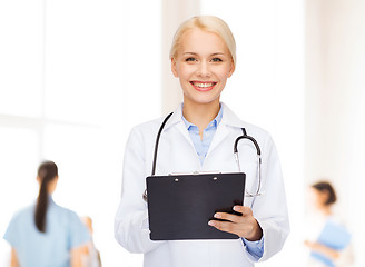 Image showing smiling female doctor with clipboard