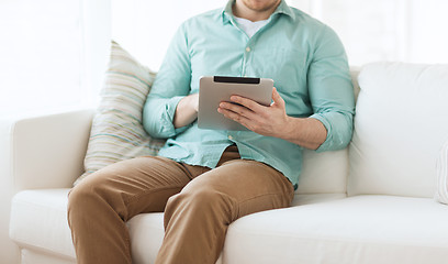 Image showing close up of man with tablet pc computer at home