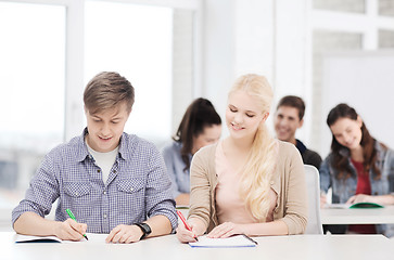 Image showing two teenagers with notebooks at school