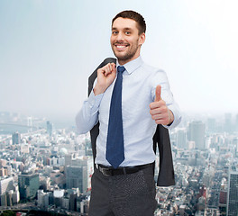 Image showing smiling young businessman showing thumbs up