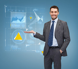 Image showing businessman showing graph on virtual screen