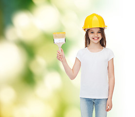 Image showing smiling little girl in helmet with paint brush