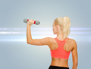 Image showing young sporty woman with light dumbbell