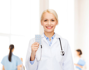 Image showing smiling female doctor with pills