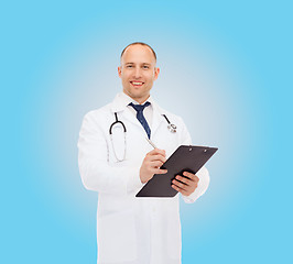 Image showing smiling male doctor with clipboard and stethoscope