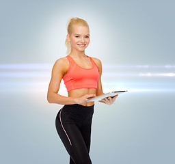 Image showing smiling sporty woman with tablet pc computer