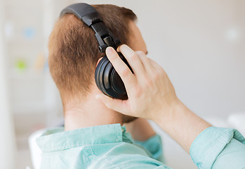 Image showing close up of man in headphones at home