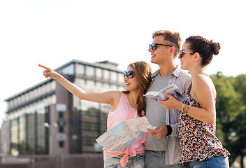 Image showing smiling friends with map and city guide outdoors