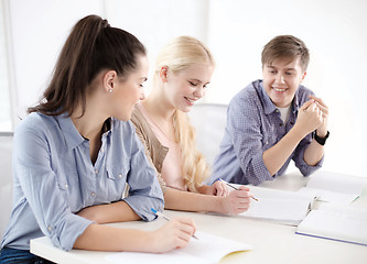 Image showing smiling students with notebooks at school