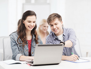 Image showing students with laptop and notebooks at school