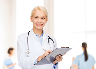 Image showing smiling female doctor with clipboard