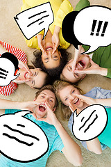 Image showing smiling people lying down on floor and screaming