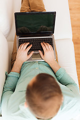 Image showing close up of man working with laptop at home