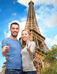 Image showing smiling couple showing thumbs up