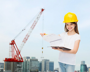 Image showing smiling little girl in hardhat with clipboard