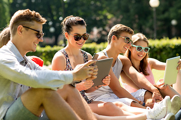 Image showing smiling friends with tablet pc computers in park