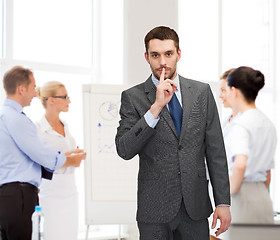 Image showing group of businessmen making hush sign