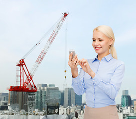 Image showing young smiling businesswoman with smartphone