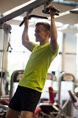 Image showing smiling man exercising in gym