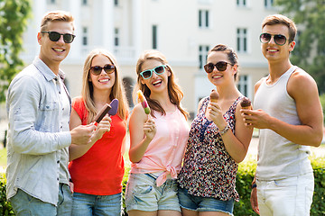 Image showing group of smiling friends with ice cream outdoors