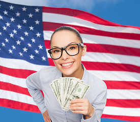 Image showing smiling businesswoman with dollar cash money