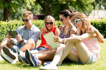 Image showing smiling friends with tablet pc computers in park