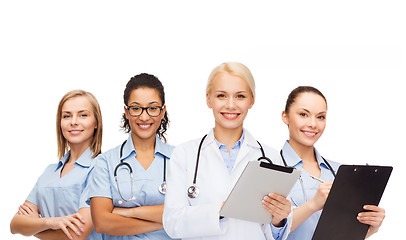 Image showing smiling female doctor and nurses with tablet pc