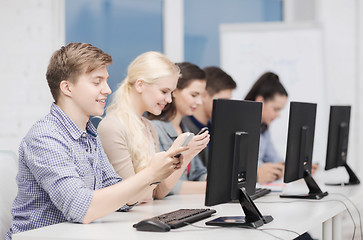 Image showing students with computer monitor and smartphones