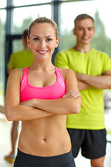 Image showing smiling man and woman in gym