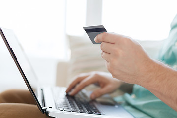 Image showing close up of man with laptop and credit card