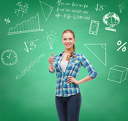 Image showing smiling student girl showing thumbs up