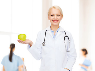 Image showing smiling female doctor with green apple