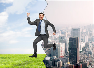 Image showing smiling happy businessman jumping