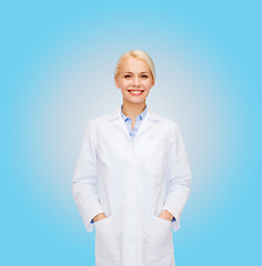 Image showing smiling female doctor over blue background