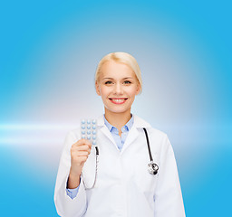 Image showing smiling female doctor with pills