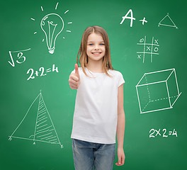 Image showing smiling girl in white t-shirt showing thumbs up