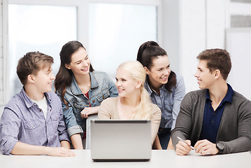 Image showing smiling students with laptop at school