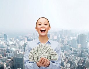 Image showing laughing businesswoman with dollar cash money