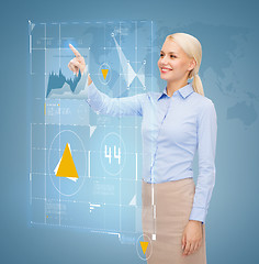 Image showing smiling businesswoman working with virtual screen