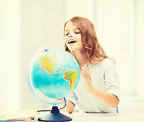 Image showing student girl with globe at school