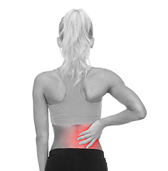 Image showing sporty woman touching her back