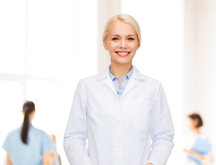 Image showing smiling female doctor with group of medics